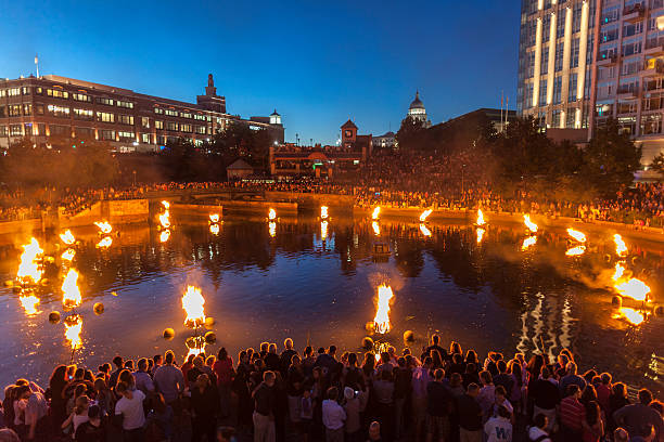"Providence, Rhode Island, USA - August 24, 2013: People line the banks of the Providence River to enjoy Waterfire. Waterfire is a free community arts event on the Providence River which begins at sunset. Waterfire was started by Barnaby Evans in 1994, and takes place about every other weekend through the summer."